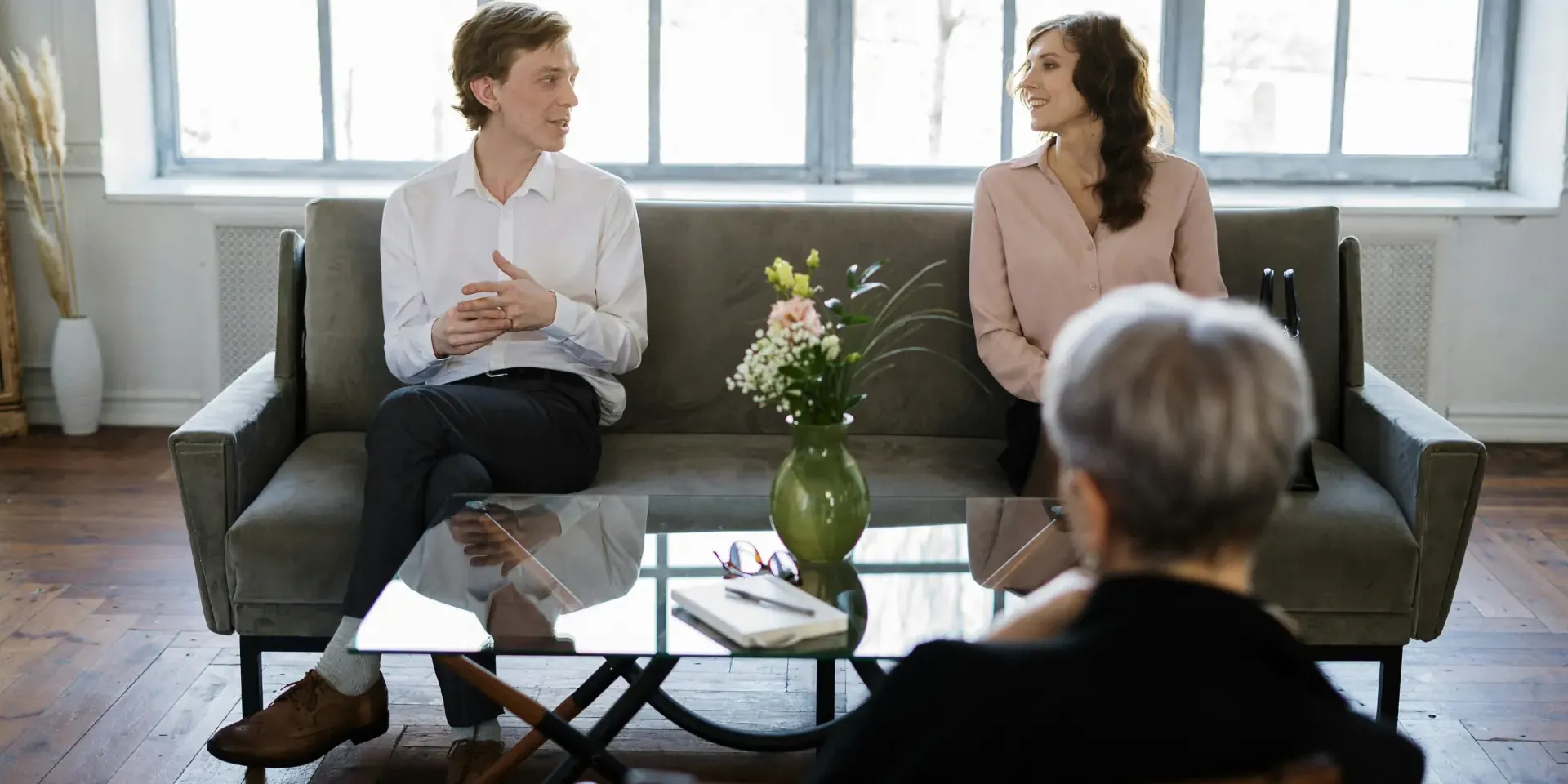 Couple happily discussing their partnership with a relationship counsellor.