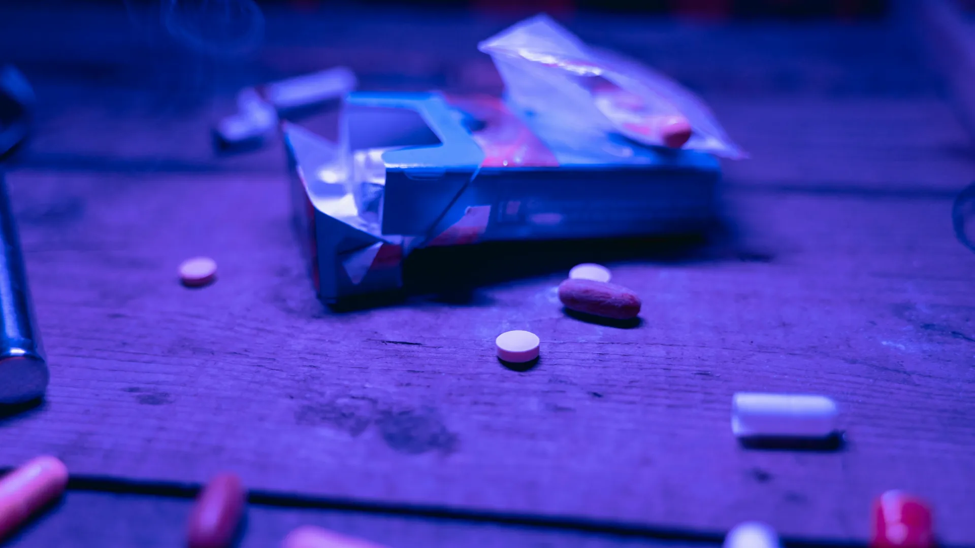 A box of assorted drugs and pills, left on a bench by someone who clearly has a drug addiction.