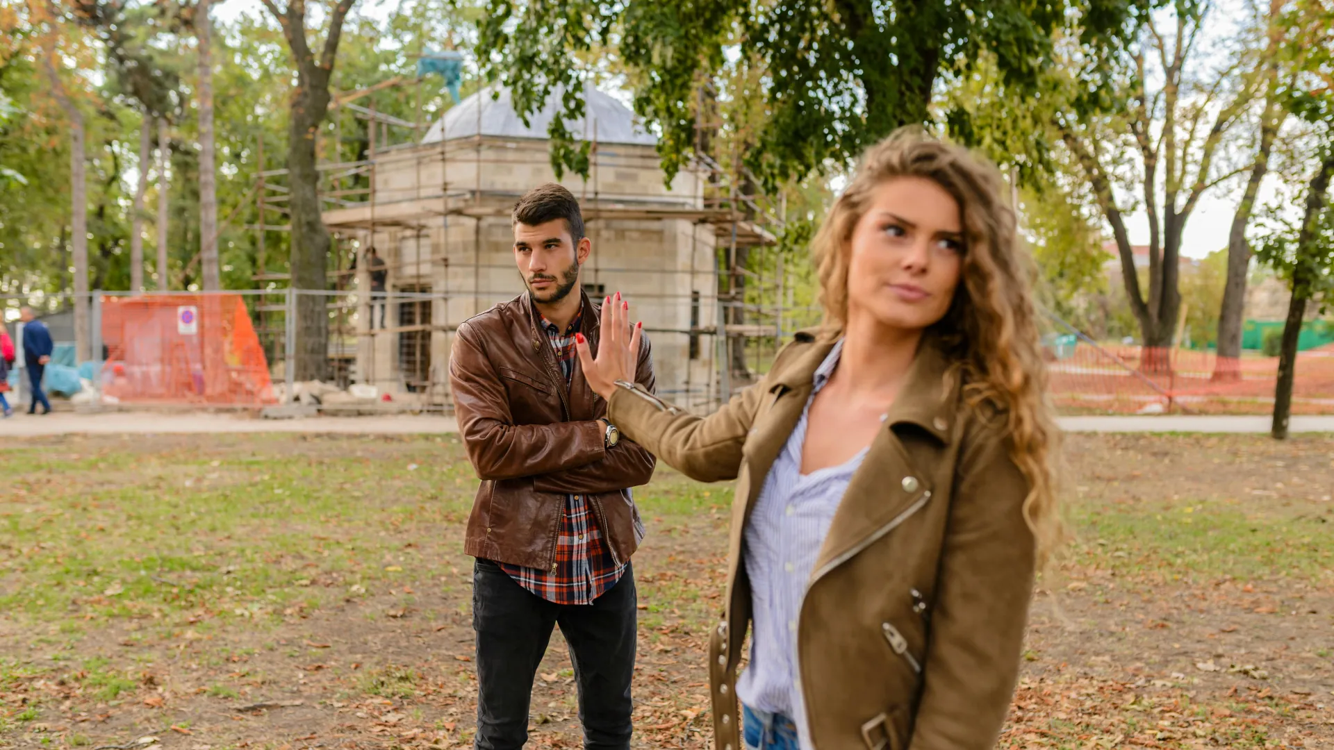 A young woman has had just about enough with her partners argumentative behaviour and is walking away to diffuse the situation.