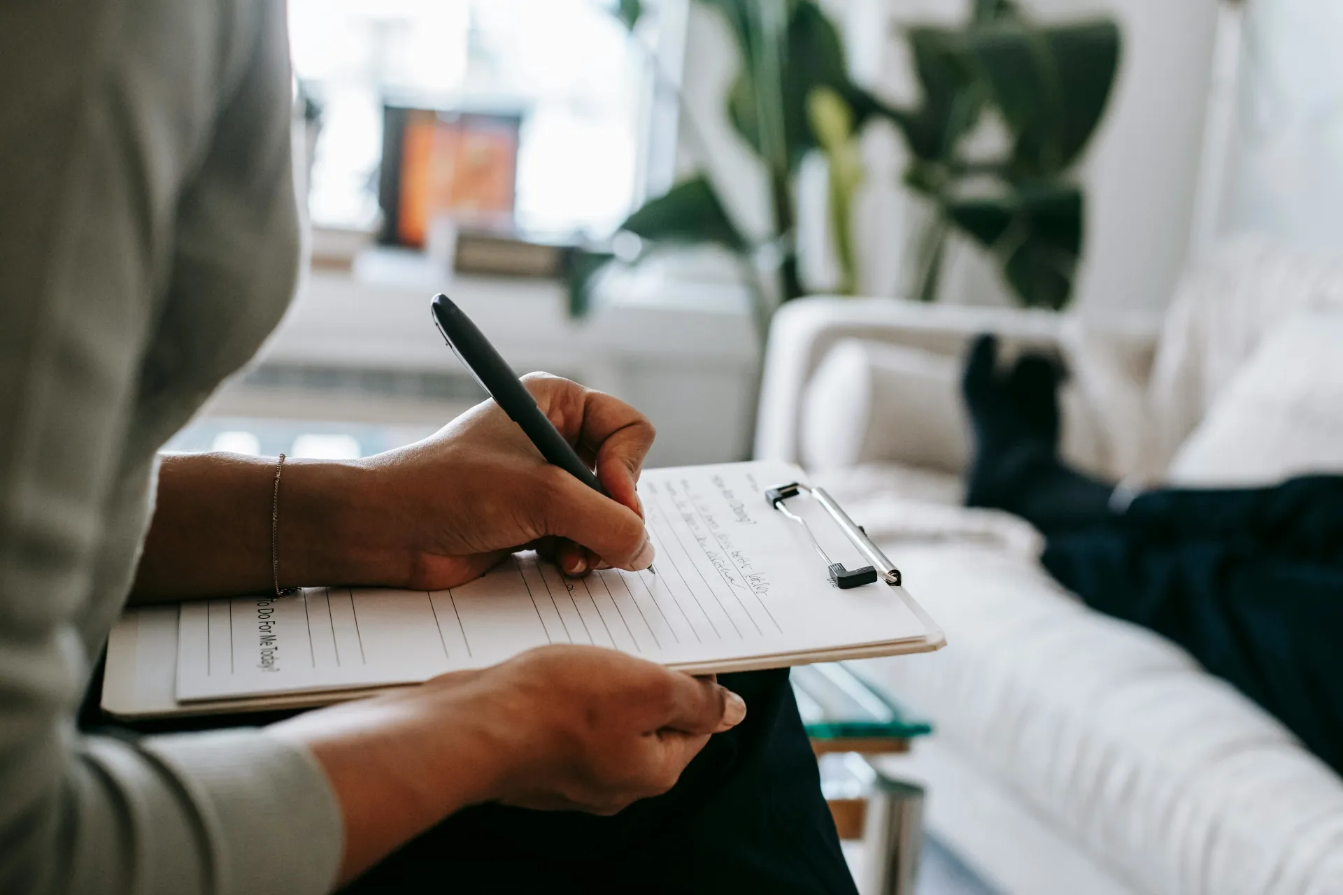 A therapist uses Cognitive Behavioural Therapy to assess their patient.